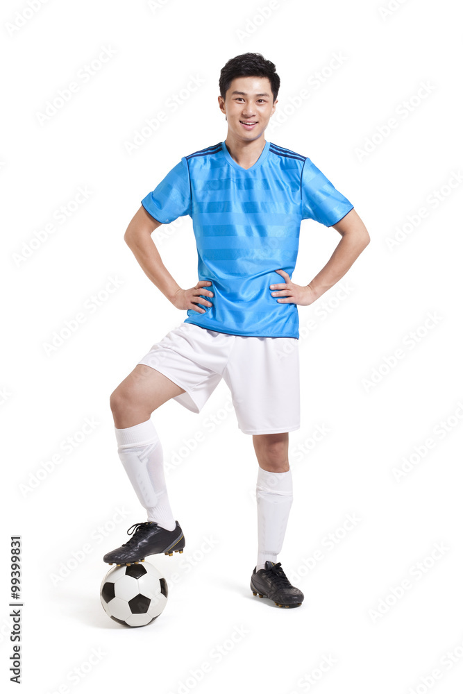 Soccer player with hands on hips smilng