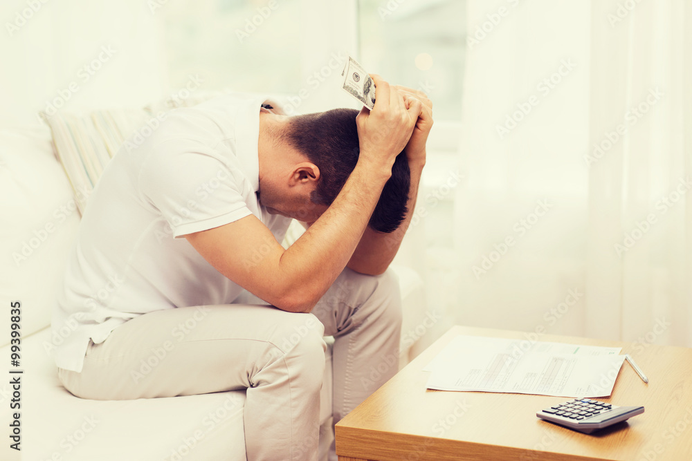 man with money and calculator at home man with money and calculator at home
