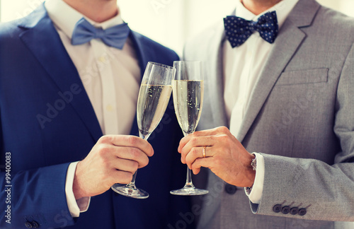 close up of male gay couple with champagne glasses photo