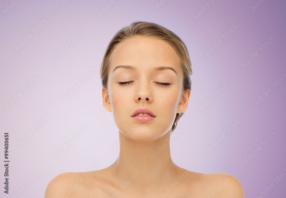 young woman face with bare shoulders over violet