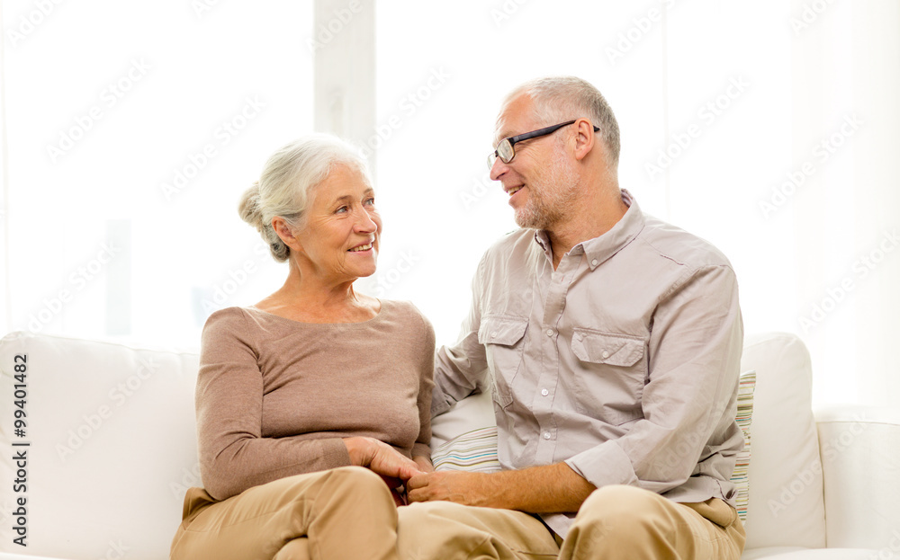happy senior couple sitting on sofa at home happy senior couple sitting on sofa at home