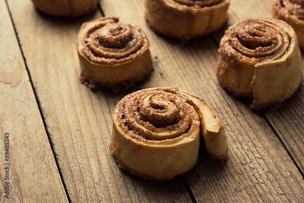 Cinnamon rolls on the wooden background Cinnamon rolls on the wooden background