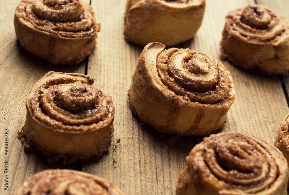 Cinnamon rolls on the wooden background