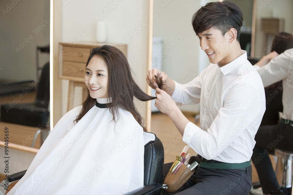 Barber cutting customer's hair Barber cutting customer's hair