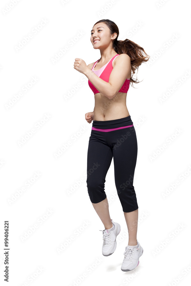 Young woman in sports clothing jumping Young woman in sports clothing jumping