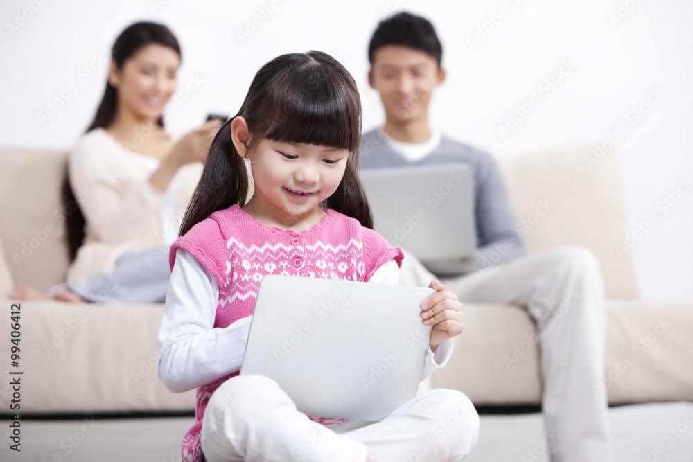 Young family using electronic gadgets in living room Young family using electronic gadgets in living room