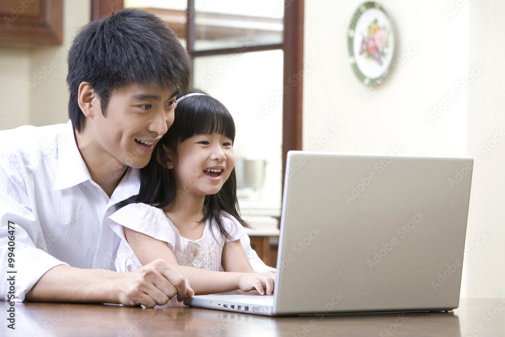 Father and daughter using laptop Father and daughter using laptop