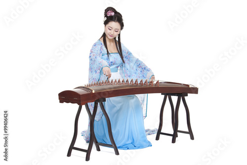 Photography Young woman in Chinese traditional costume plucking Chinese zither
