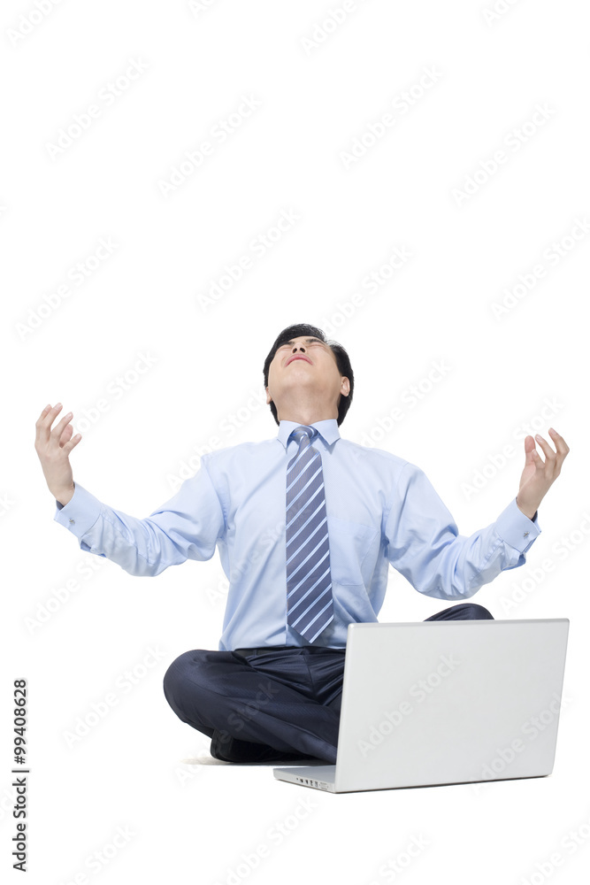 A frustrated businessman sitting on the floor with his laptop A frustrated businessman sitting on the floor with his laptop