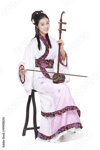 Young woman in Chinese traditional costume plucking Erhu
