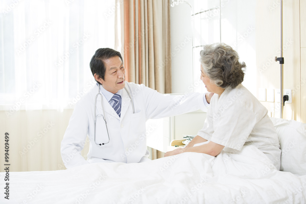 Doctor talking with patient in hospital Doctor talking with patient in hospital