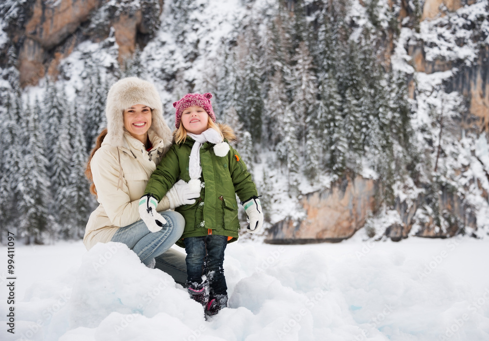 Portrait of happy mother and child in front of snowy mountains Portrait of happy mother and child in front of snowy mountains