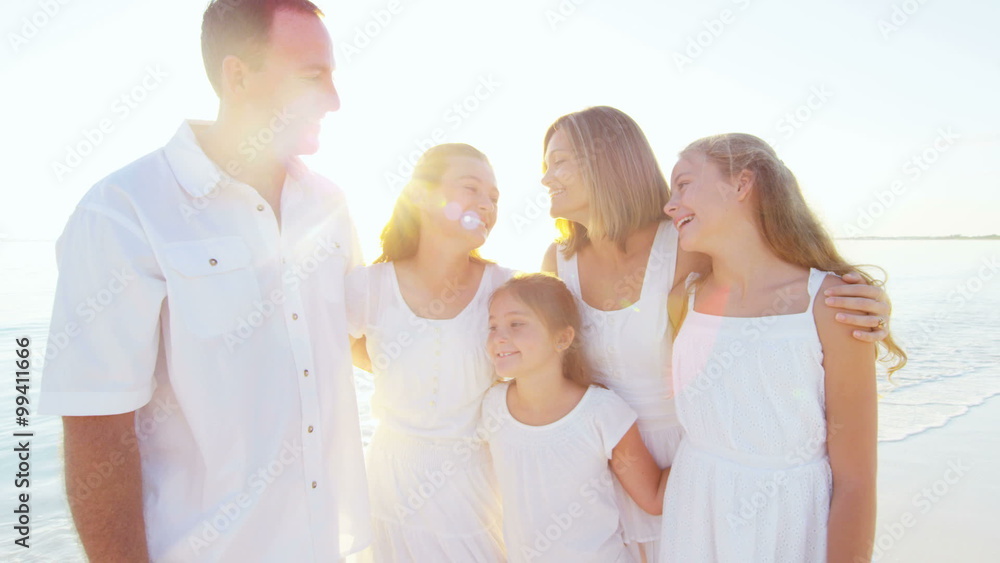Portrait of a smiling Caucasian family wearing white clothes on beach Portrait of a smiling Caucasian family wearing white clothes on beach