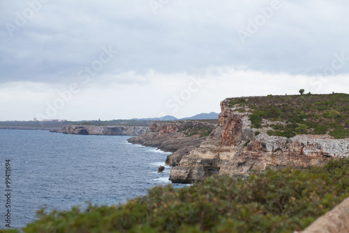 Beautiful beach bay azure sea water, rainy weather, cloudly. Majorca island, Spain