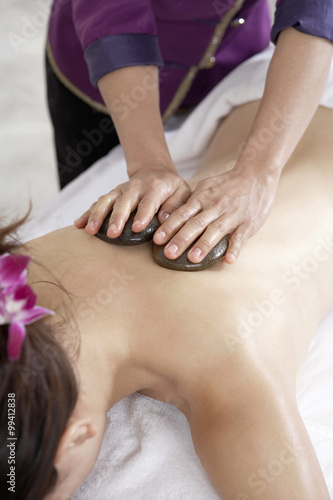 Woman Receiving A Hot Stone Massage