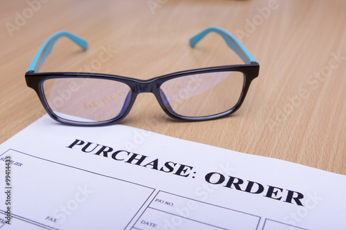 Purchase order form on wooden table