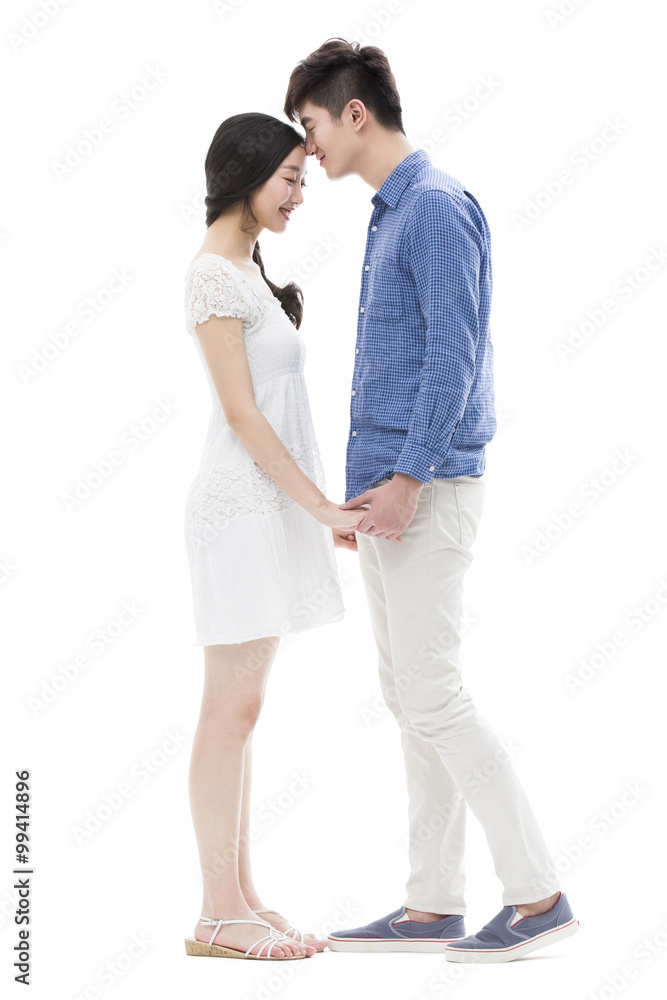 Young man kissing girlfriend on forehead