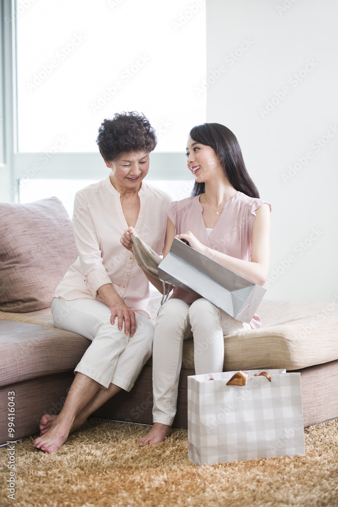 Daughter showing new clothes to mother Daughter showing new clothes to mother