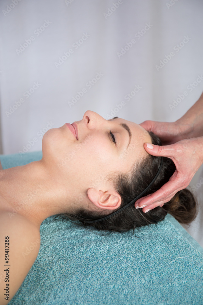 Happy beautiful brunette woman taking head massage Happy beautiful brunette woman taking head massage