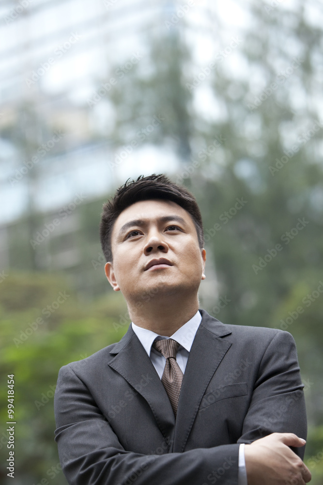 Confident businessman arms crossed, Hong Kong Confident businessman arms crossed, Hong Kong