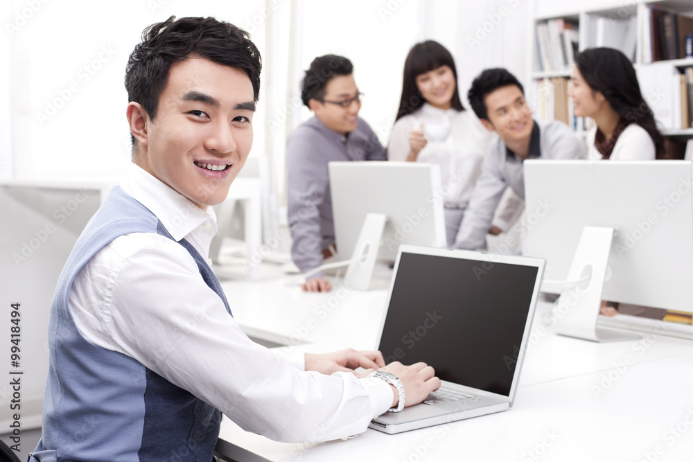 Male office worker using laptop in studio Male office worker using laptop in studio