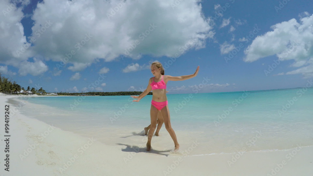 Caucasian young girls in swimwear having fun playing Caucasian young girls in swimwear having fun playing