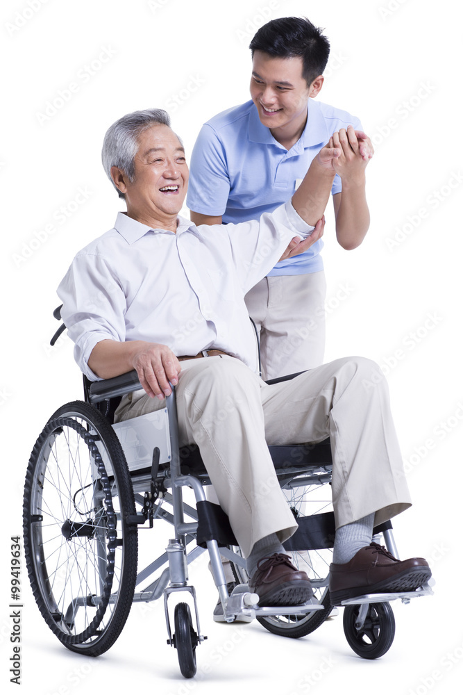 Male nursing worker helping senior man doing exercise Male nursing worker helping senior man doing exercise