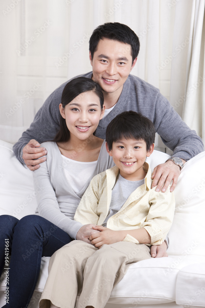 Young family sitting in couch