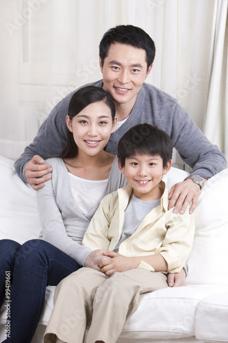 Young family sitting in couch