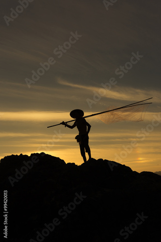 Fisherman action on stone sunset