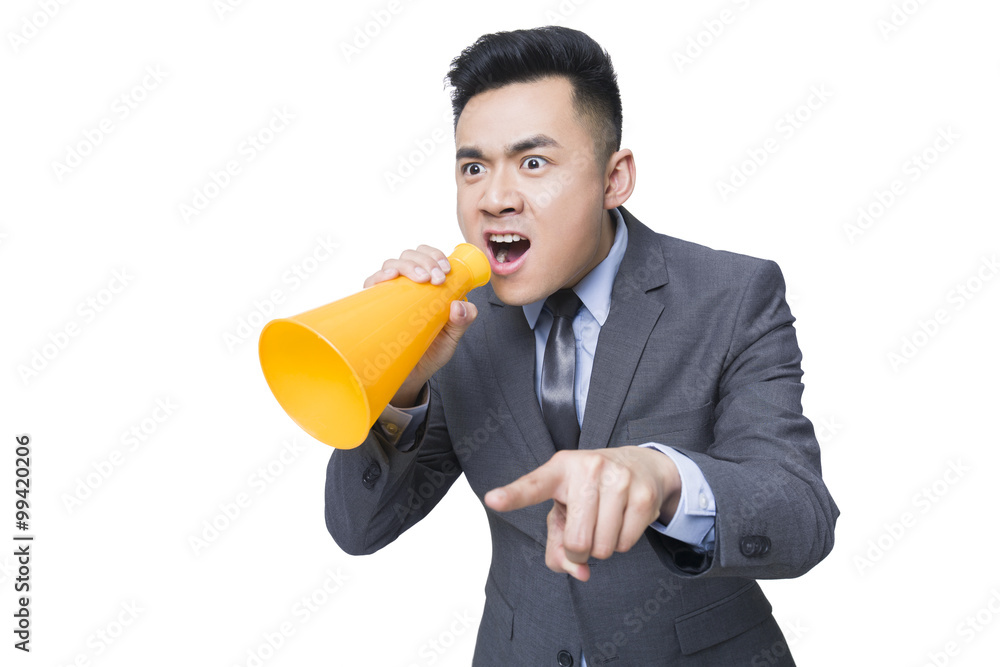 Young businessman shouting into megaphone Young businessman shouting into megaphone