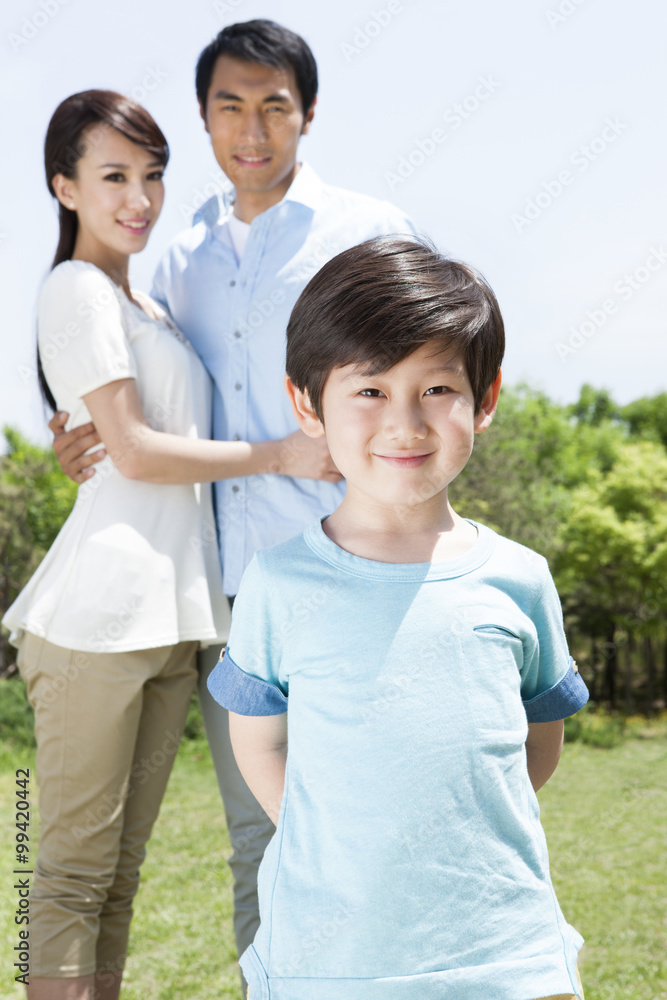 Portrait of young family on grass Portrait of young family on grass