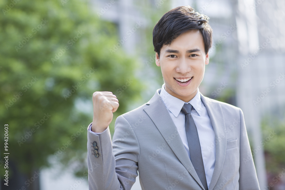Young businessman cheering Young businessman cheering