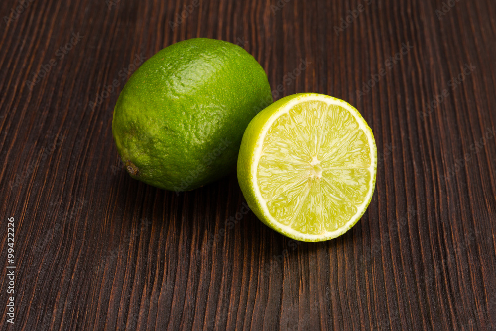 Group of fresh limes on dark wooden table Group of fresh limes on dark wooden table