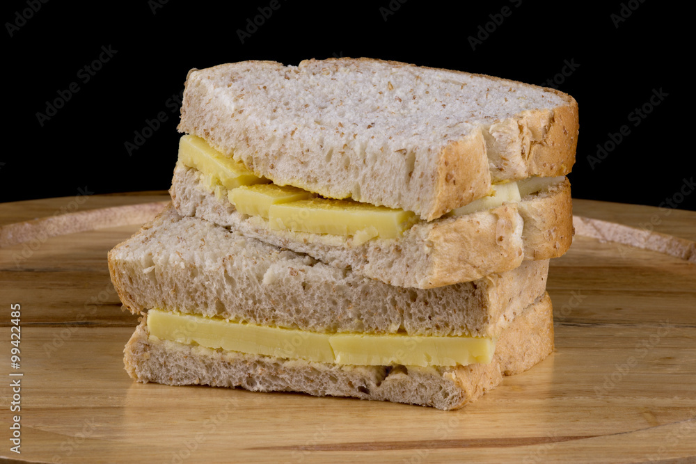 Cheese and Mustard Sandwiches on Wooden Cutting Board