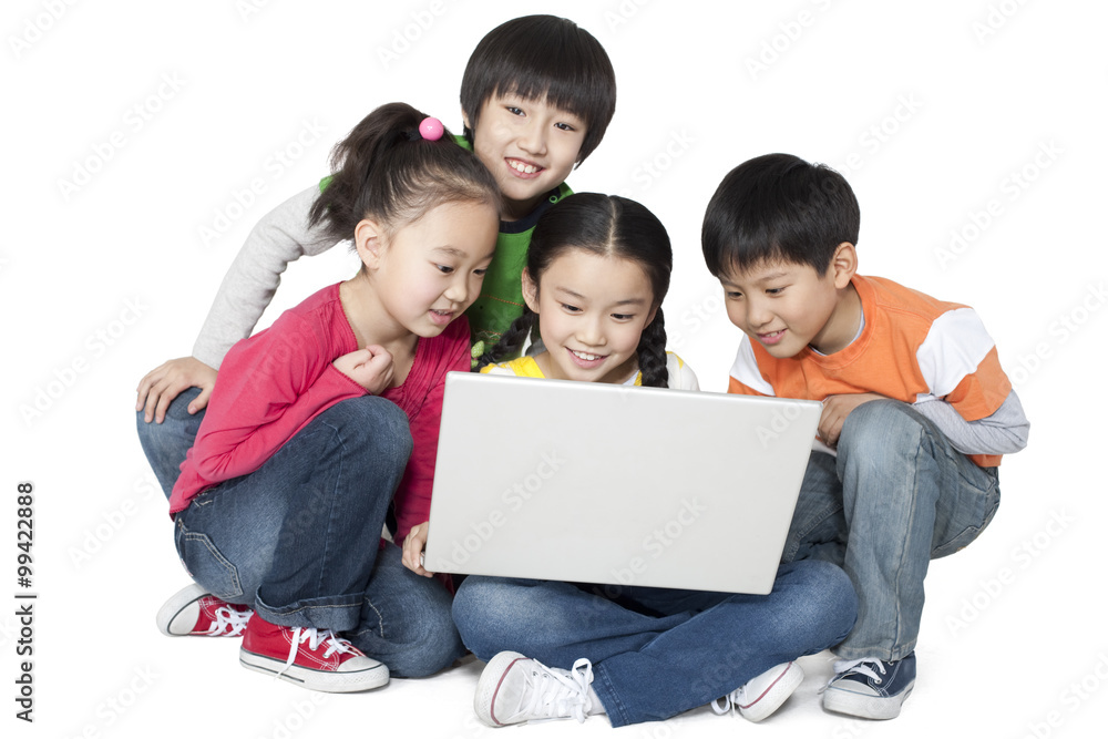 A group of children using a laptop together A group of children using a laptop together