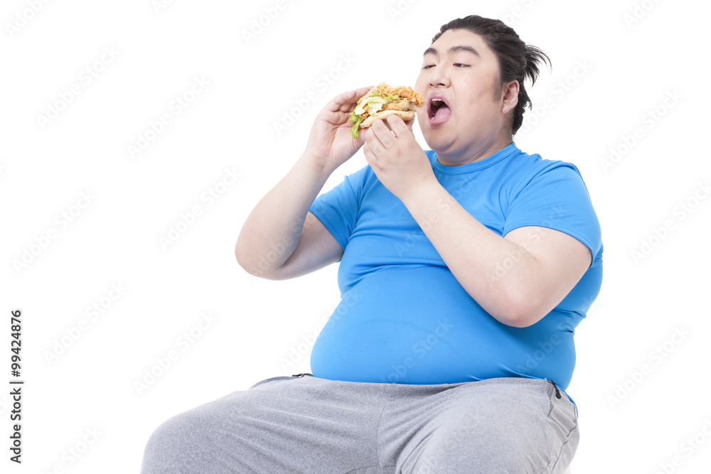 Greedy Chubby man gobbling a burger Greedy Chubby man gobbling a burger
