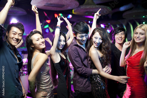 Stylish young people dancing in nightclub