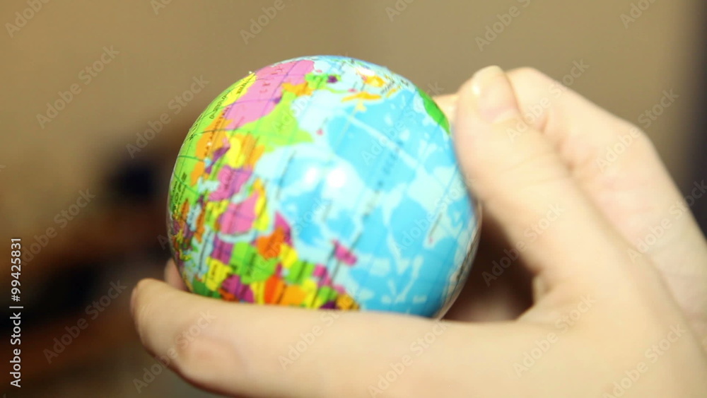 small globe in the hands of women small globe in the hands of women