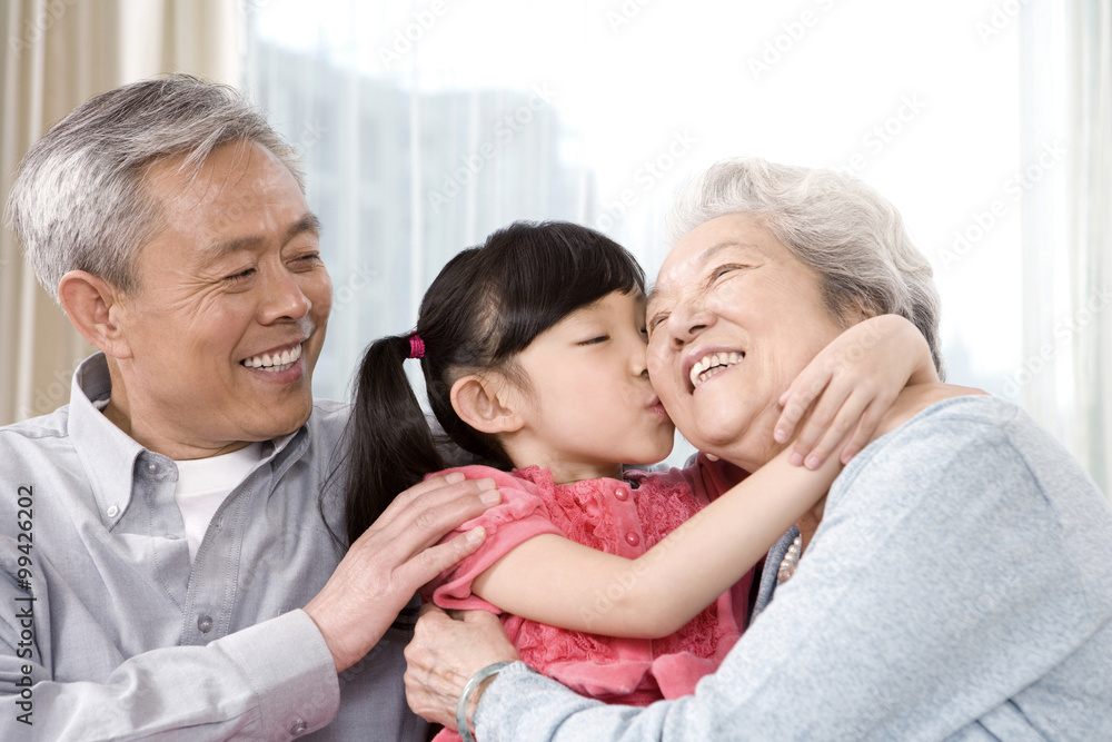 Elderly couple with granddaughter on couch Elderly couple with granddaughter on couch