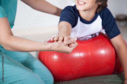 Therapist woman with boy in rehab