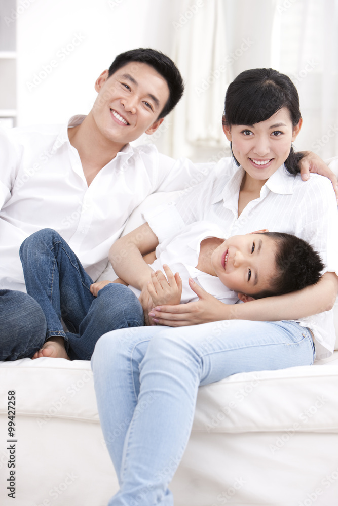 Happy family sitting in sofa