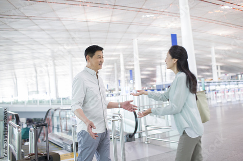 Mature couple reuniting at airport