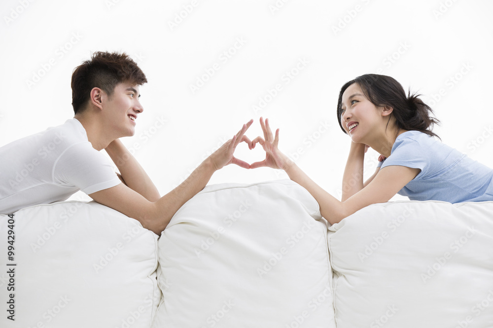 Young couple making heart shape with their hands Young couple making heart shape with their hands