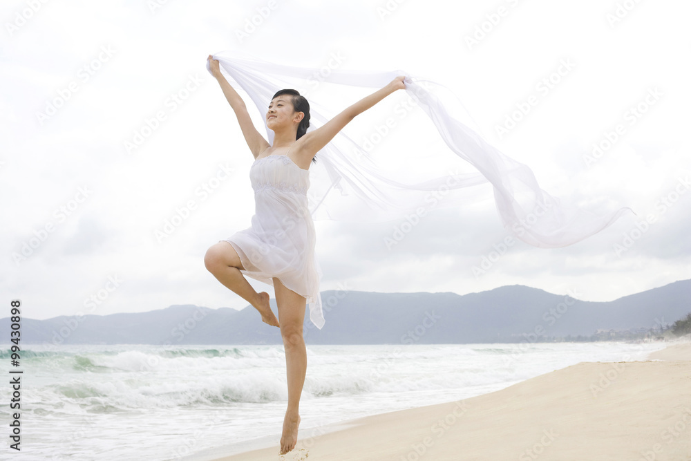 A woman dancing at the beach A woman dancing at the beach