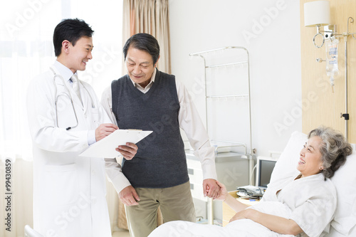 Doctor with senior couple in hospital