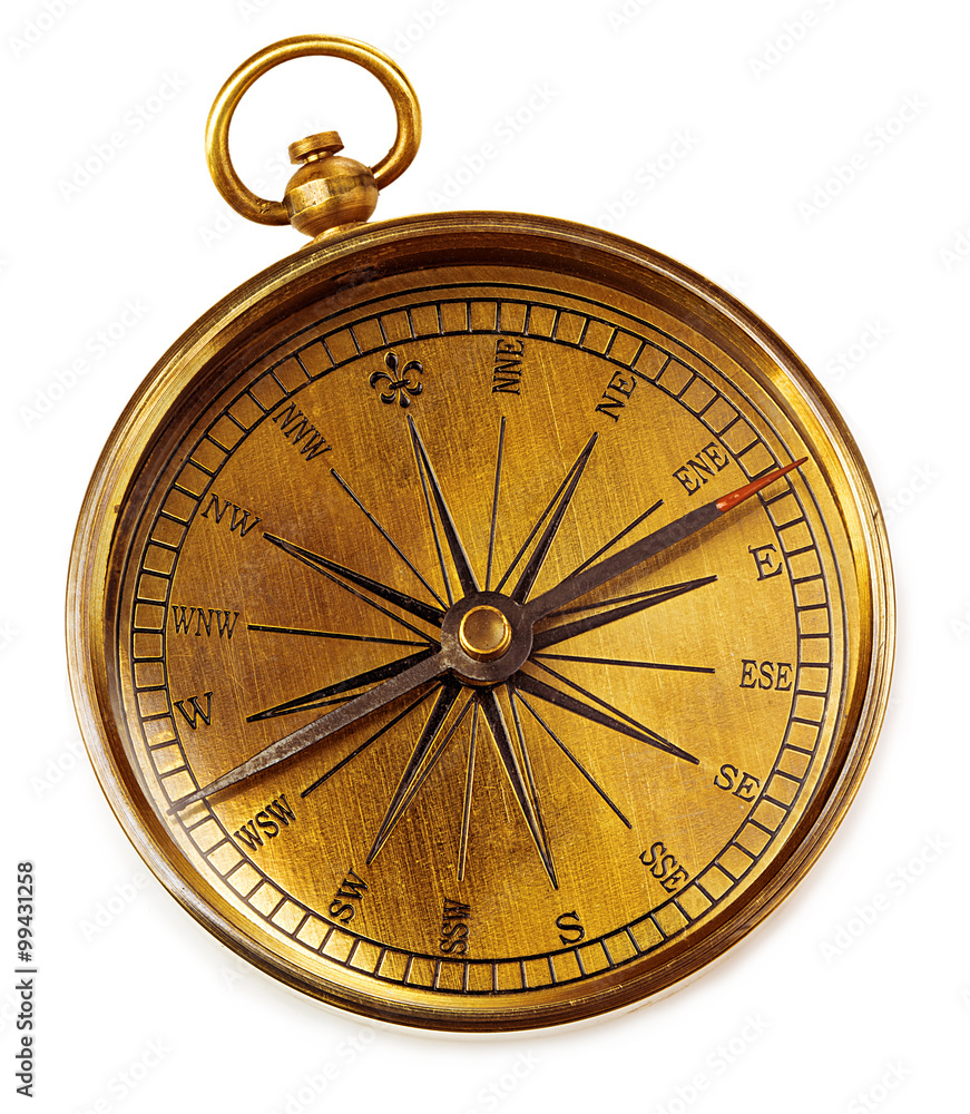 Old vintage brass compass isolated on a white background.