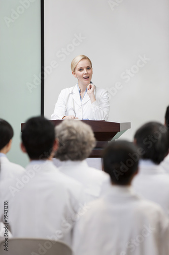 Female doctor giving speech in boardroom