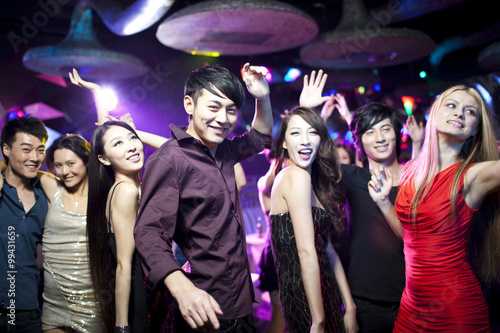 Stylish young people dancing in nightclub