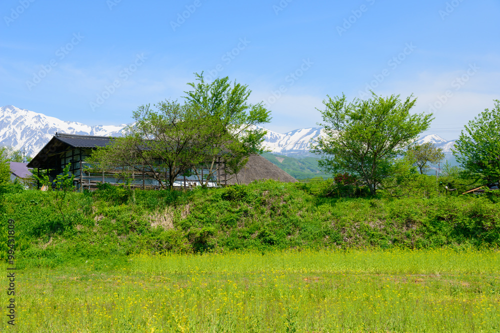 Shirouma mountains and old houses at Ooide park in Hakuba, Nagano, Japan Shirouma mountains and old houses at Ooide park in Hakuba, Nagano, Japan